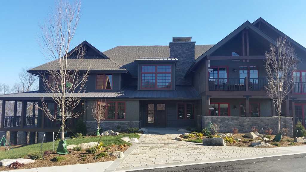 Large craftsman-style house with stone chimney