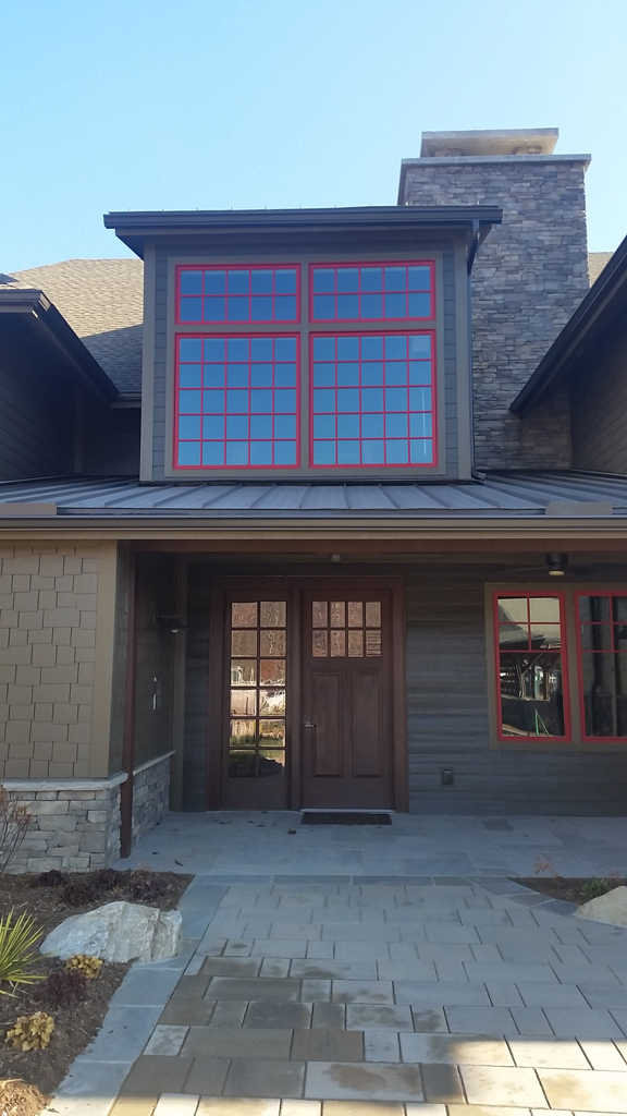 House entrance with large red-trimmed windows