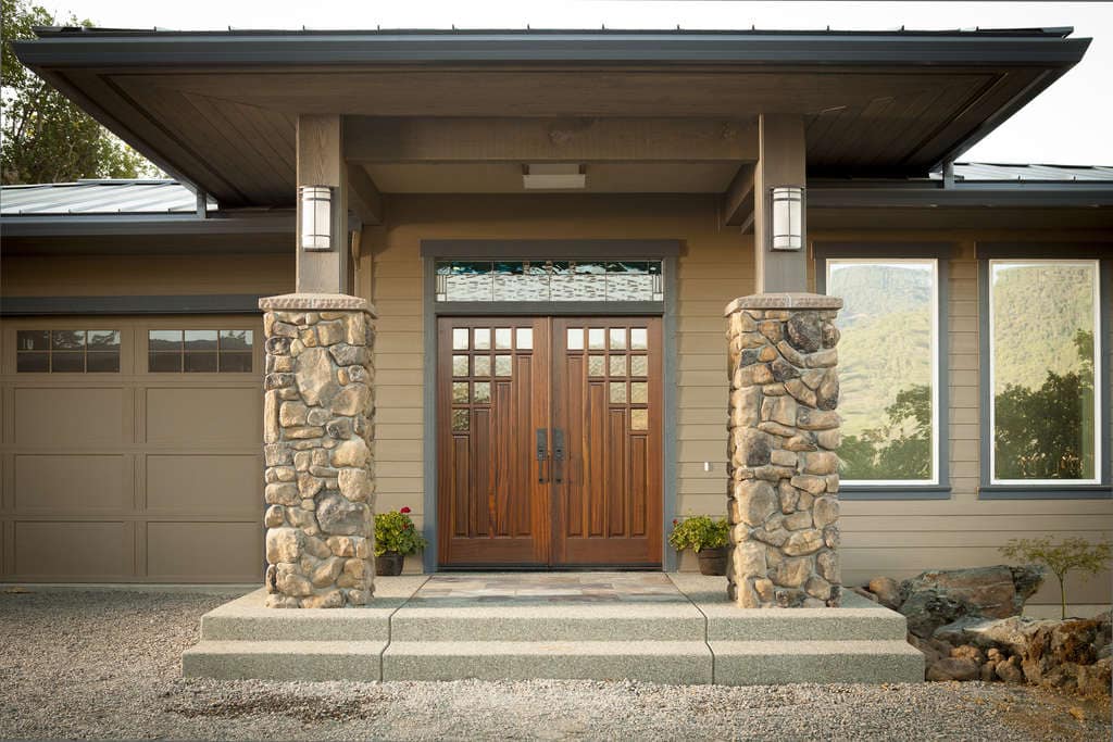 Front porch with wooden double doors and columns