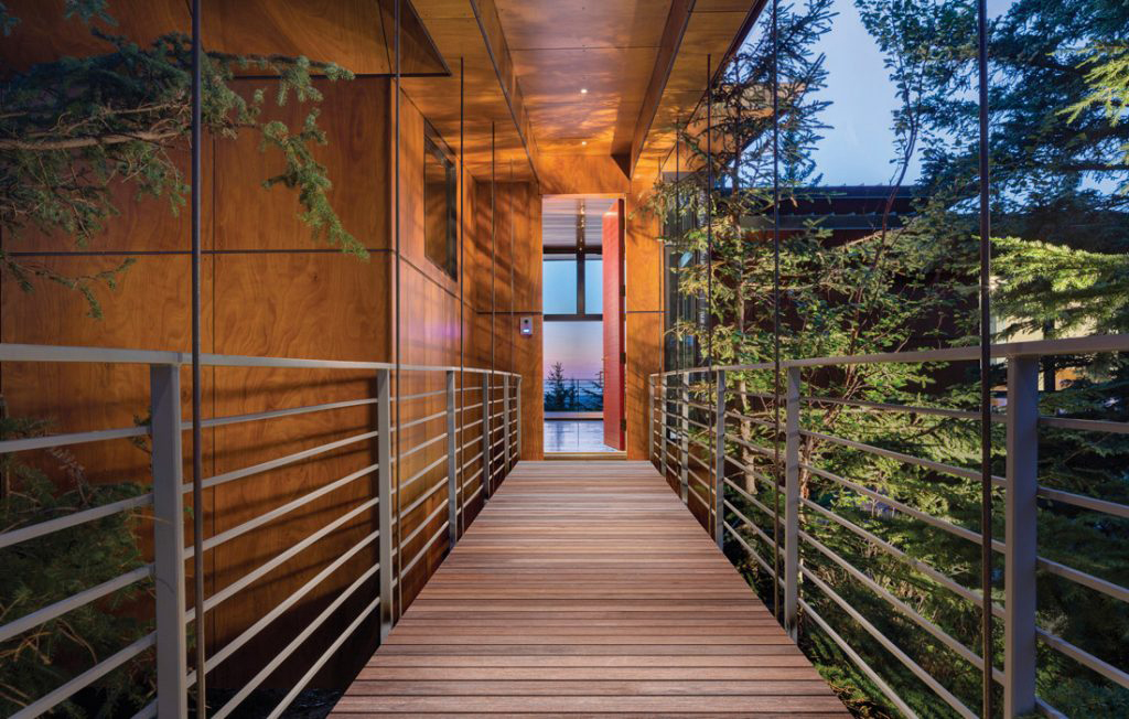 Elevated wooden walkway to modern house