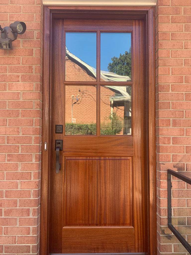 Wooden front door with four glass panes
