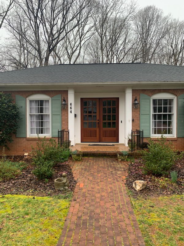 Suburban brick house with wooden double doors
