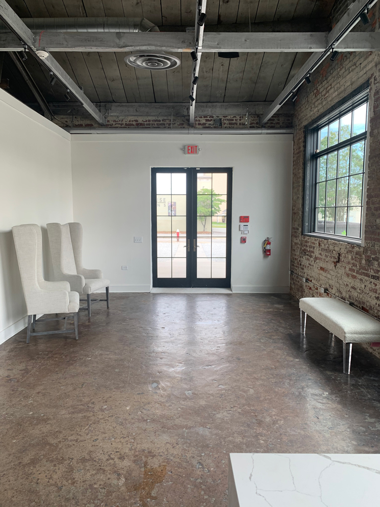 Empty industrial loft room with chairs and doors