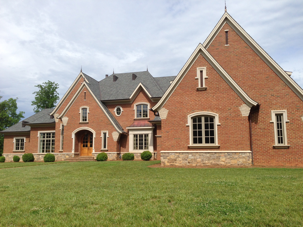 Large brick house with green front lawn