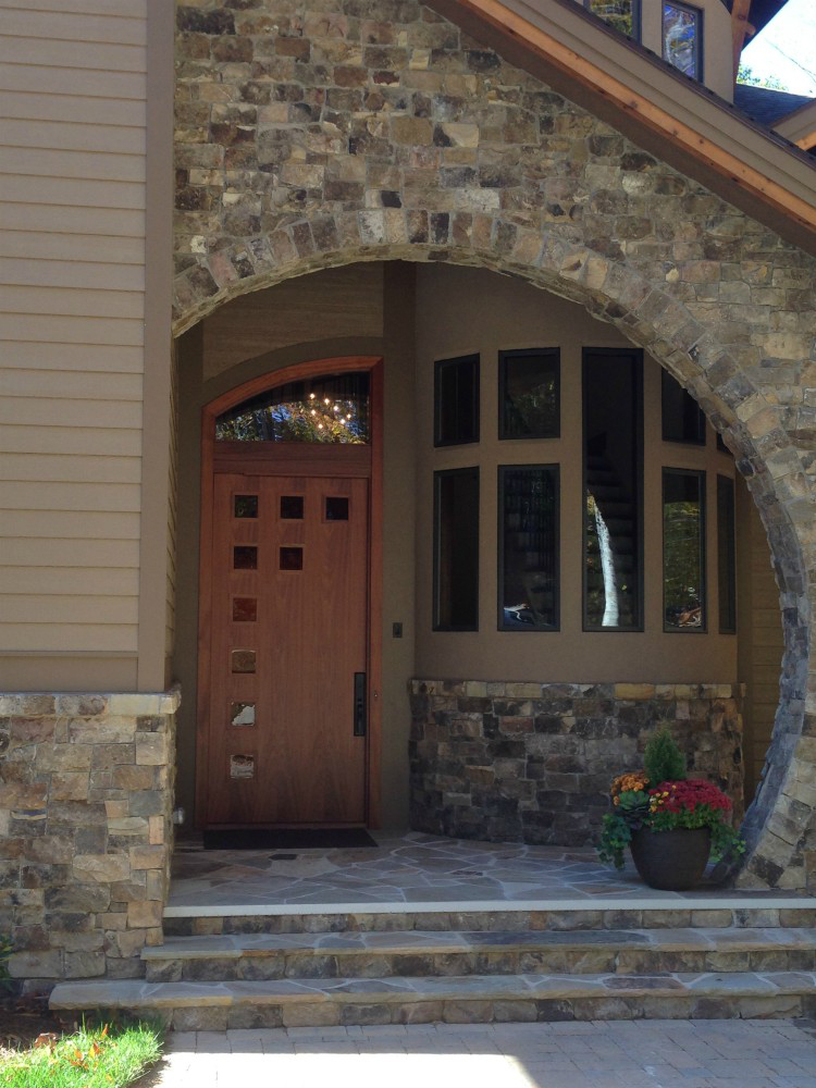 Circular stone arch entryway with wooden door
