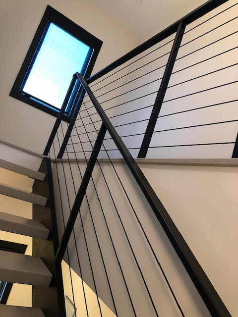 Modern metal staircase with cable railing
