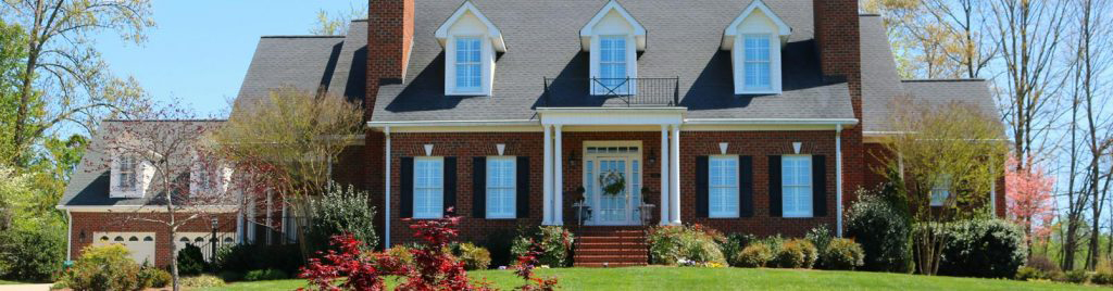 Brick colonial house with manicured lawn