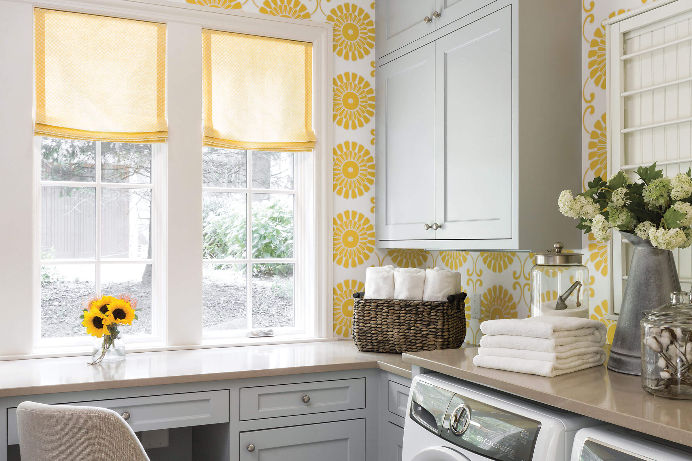 Bright laundry room with yellow floral wallpaper