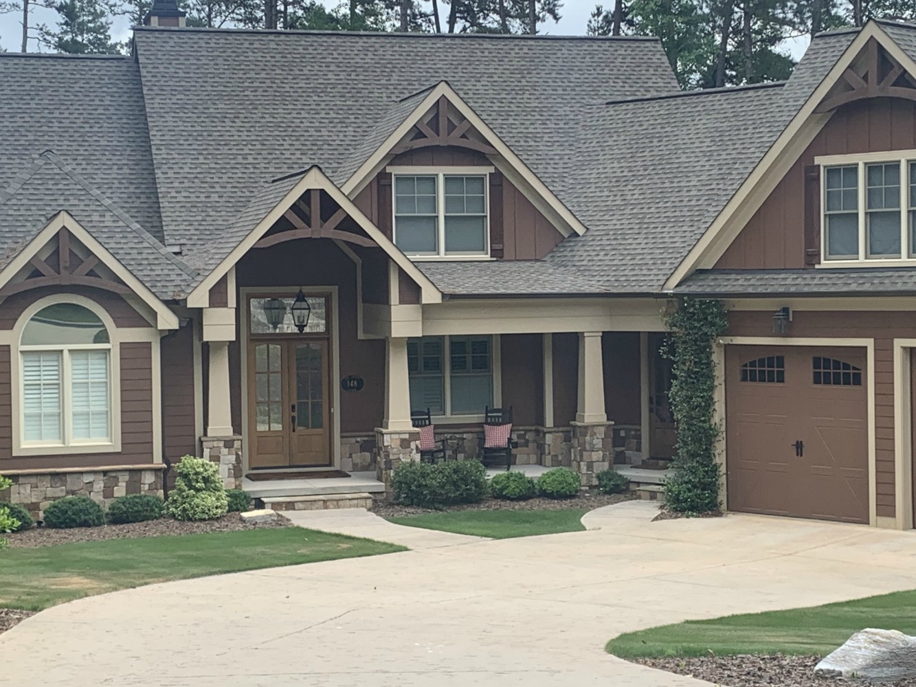 Brown craftsman style house with garage
