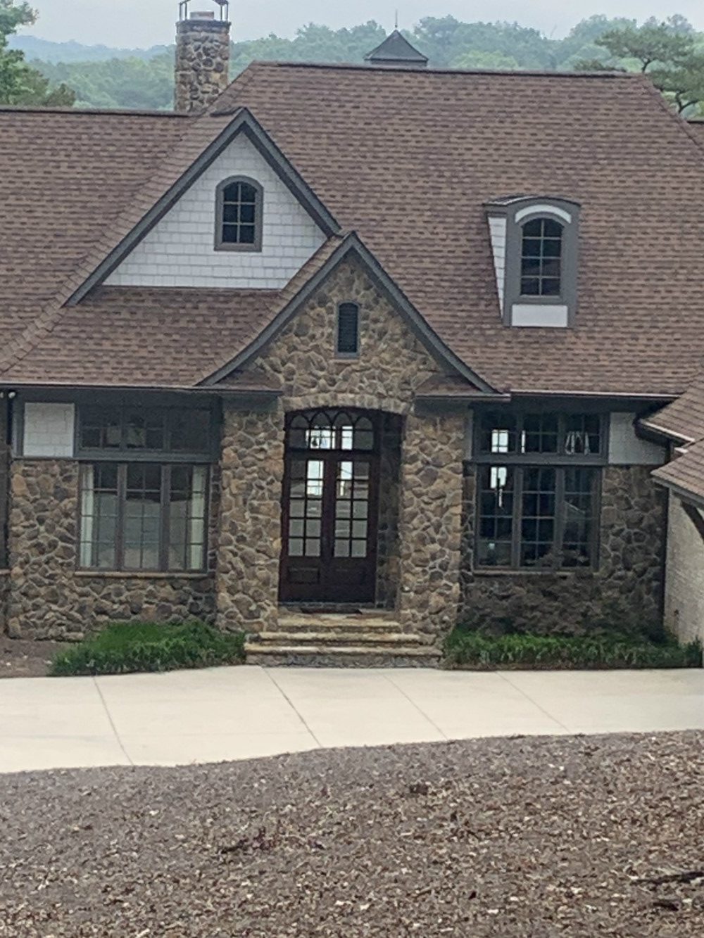 Stone house front entrance with dormer windows