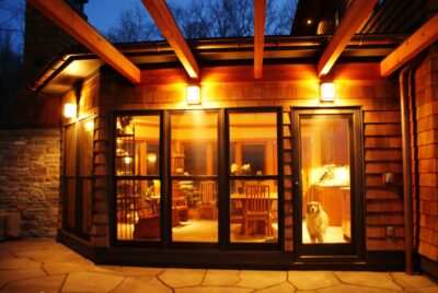 Warm-lit patio doors with dog inside.
