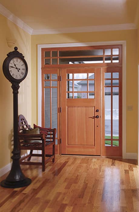 Wooden entryway door with sidelights and clock