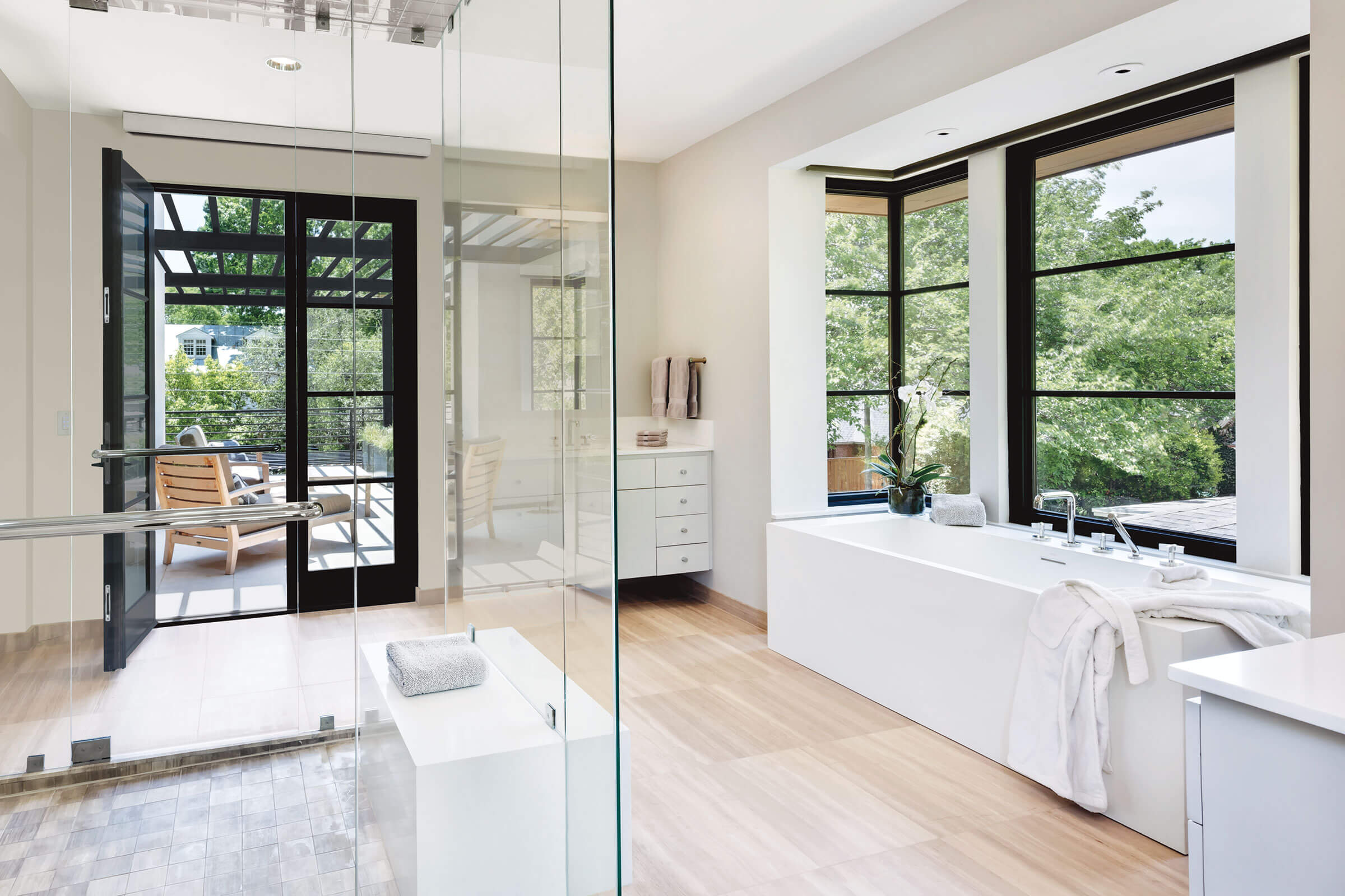 Modern bathroom with freestanding tub and windows