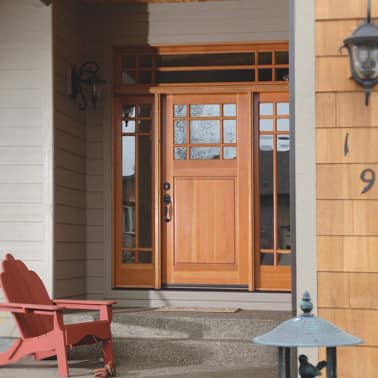 Wooden front door with sidelights and chair